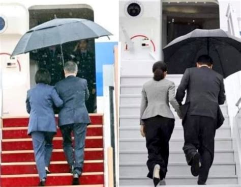 韩总统雨中撑伞不顾老婆
